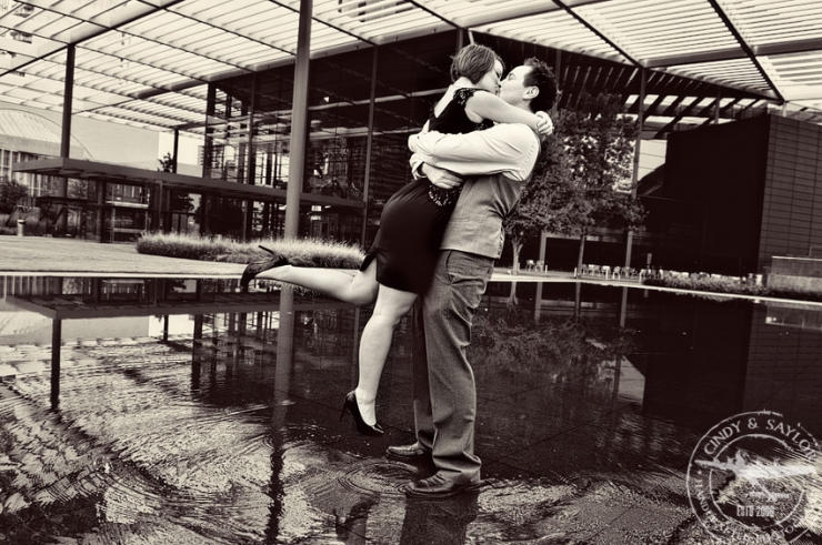 engaged couple in reflecting pool in front of the winspear opera house dallas texas