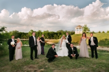 bridal party photo at the milestone in denton with lake and gazebo in the background