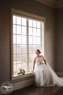 bride in front of large window Bridal session at The Milestone in Denton Texas